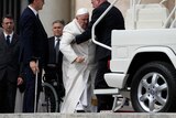 Pope Francis helped to get on his car.