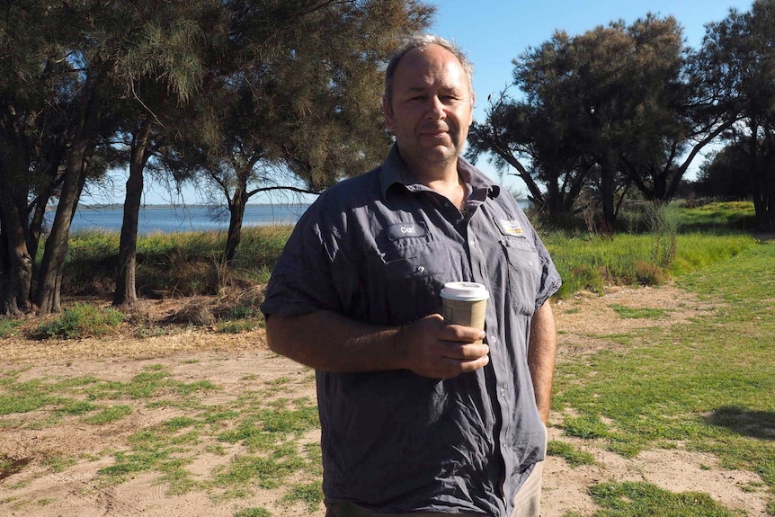 Australind resident Carl Denton stands with a takeaway coffee in Australind.