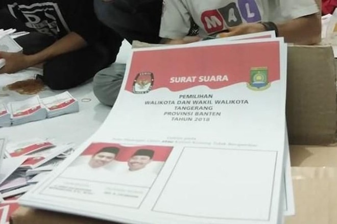 A small stack of ballot papers printed with Indonesian language.