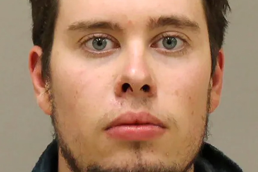 A police headshot of a man with brown hair and hazel eyes looking deadpan at the camera.