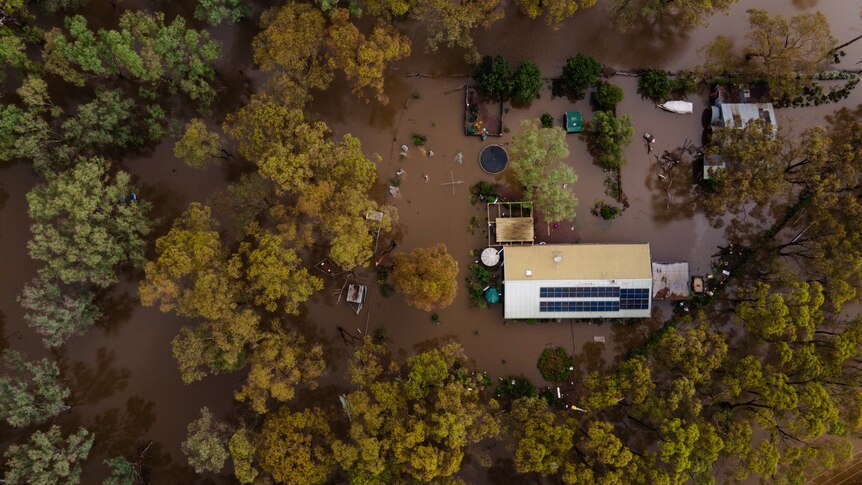 A birds eye view of a property inundated with floodwater.