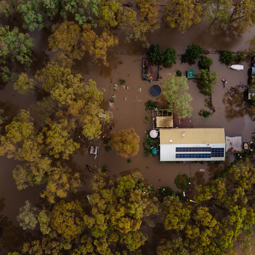 A birds eye view of a property inundated with floodwater.