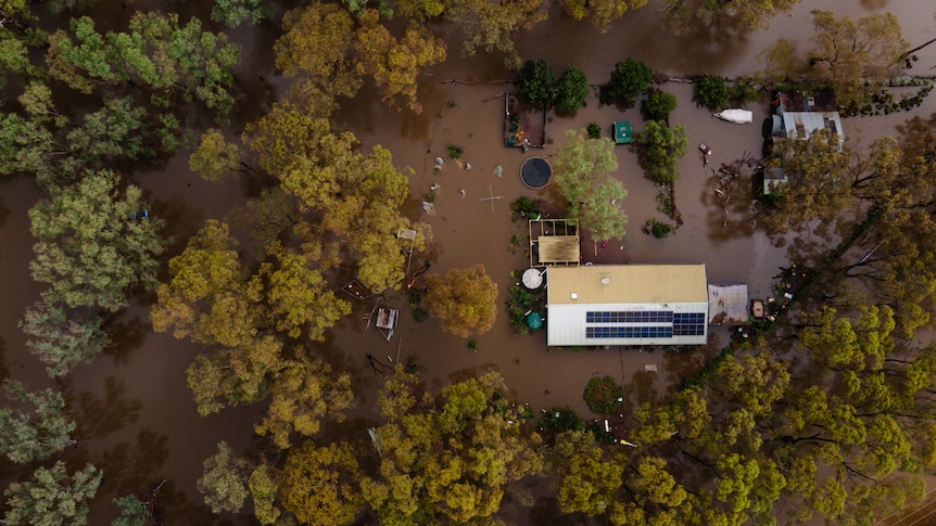 A birds-eye-view of a property inundated with flood water.