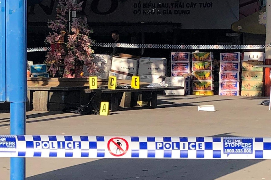 Police tape surrounding a crime scene at a shopping centre