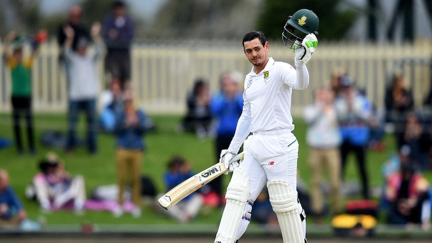 Quinton De Kock raises his bat after reaching century