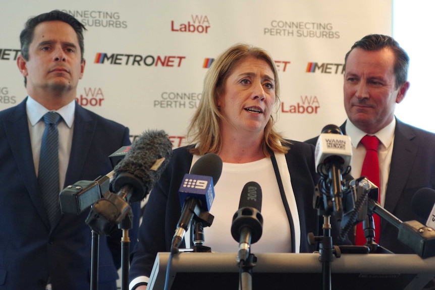 Rita Saffioti flanked by shadow treasurer Ben Wyatt (l) and Opposition Leader Mark McGowan in front of microphones.