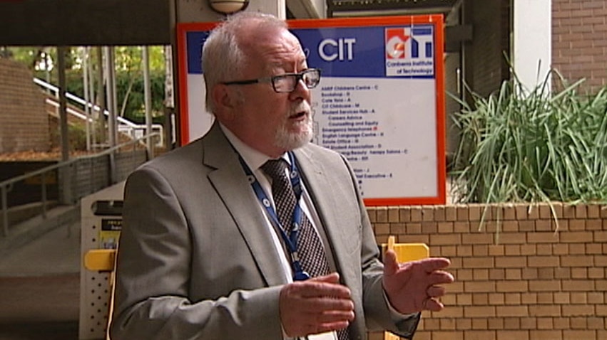 Video still: Side view of CIT Chief executive Adrian Marron in front of sign. May 2012