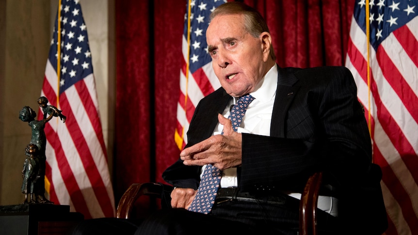 Bob Dole speaks from his chair.