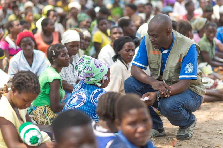 Elisha Kapalamula spends time talking to villagers at a charity food distribution