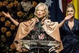 Blanche d'Alpuget raises her hands as she speaks at the memorial service for her husband Bob Hawke.
