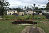 Huge hole opens up in backyard at Ipswich.
