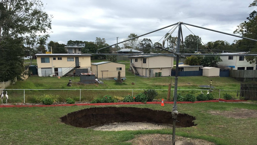 Huge hole opens up in backyard at Ipswich.