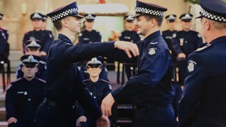 Constable Joshua Prestney (left) was presented with his police badge by his brother, Alex (right), who is also an officer.