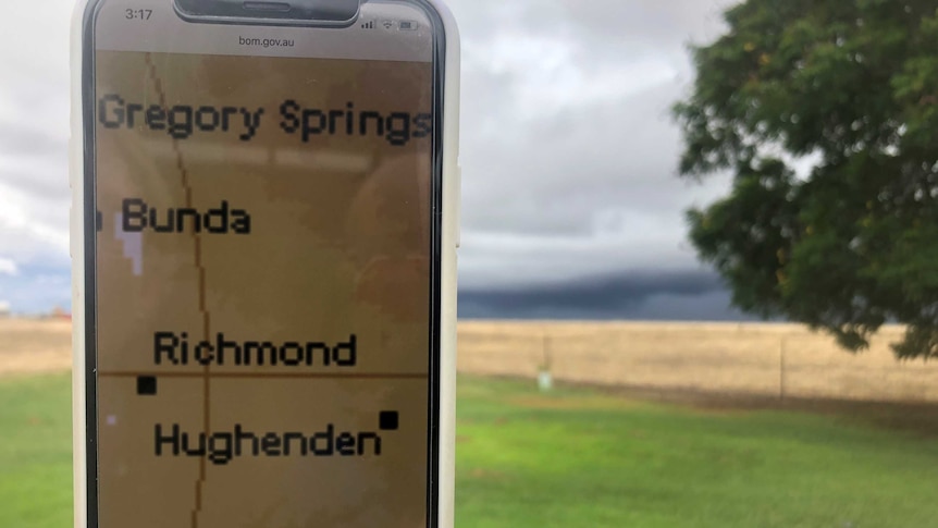 A phone with the weather radar open in a storm