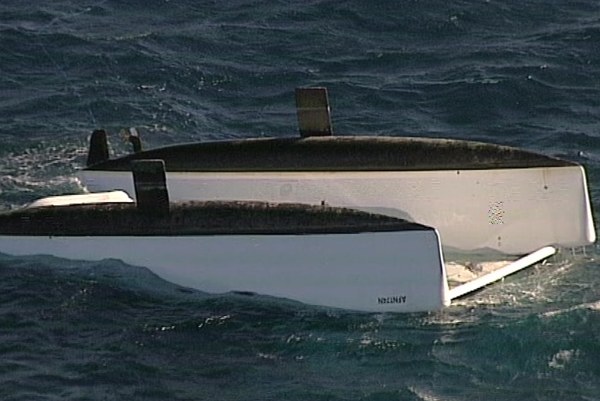 The upturned catamaran in open water
