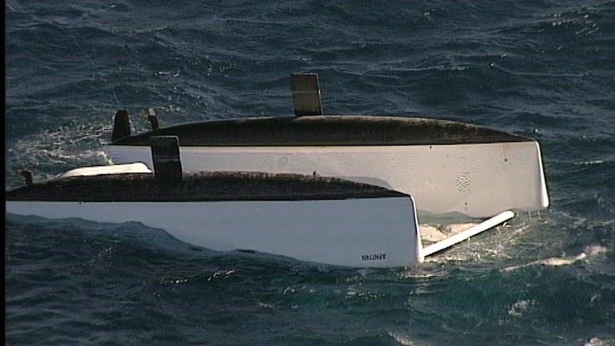 The upturned catamaran in open water