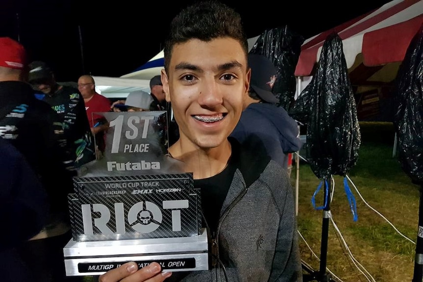 Thomas Bitmatta wins holds his first place world cup trophy in Indiana.