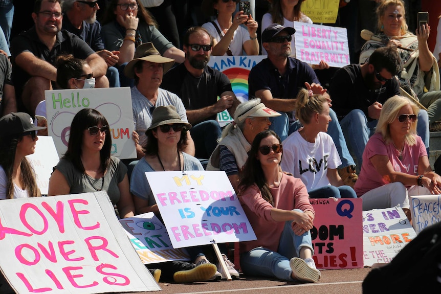 Protesters sit at an anti-lockdown demonstration in Perth.