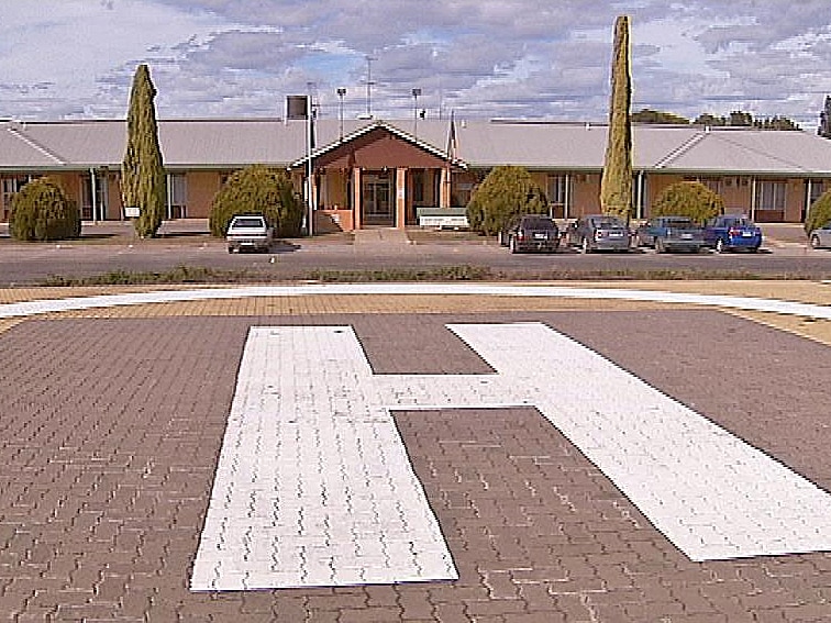 A photo of the Balaklava Hospital showing the building in the background and a helipad in the foreground.