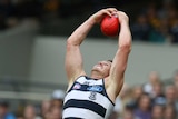 Geelong's Patrick Dangerfield takes a high mark against Hawthorn at the MCG on March 28, 2016.