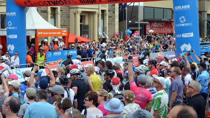 Riders cross the start line of stage 1 of the Tour Down Under.