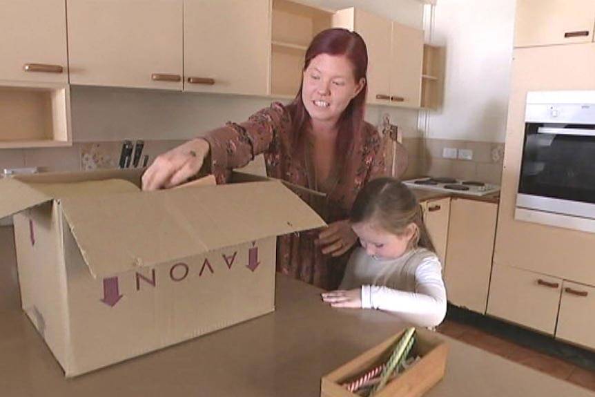 Sam Blackadder and her daughter packing kitchen utensils into a box