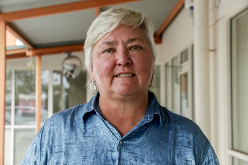 Northern Territory senator Sam McMahon stands outside an office looking at the camera.