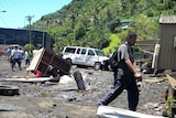 A man walks along a devastated street in the American Samoan capital of Pago Pago.
