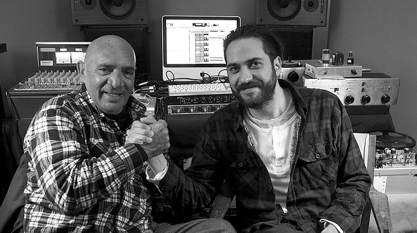 Vic Simms and Luke Peacock grip hands as a show of solidarity in the studio