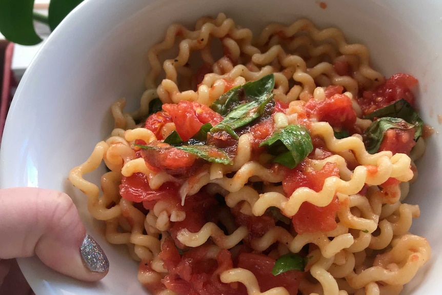 A bowl of basil and fresh tomato pasta