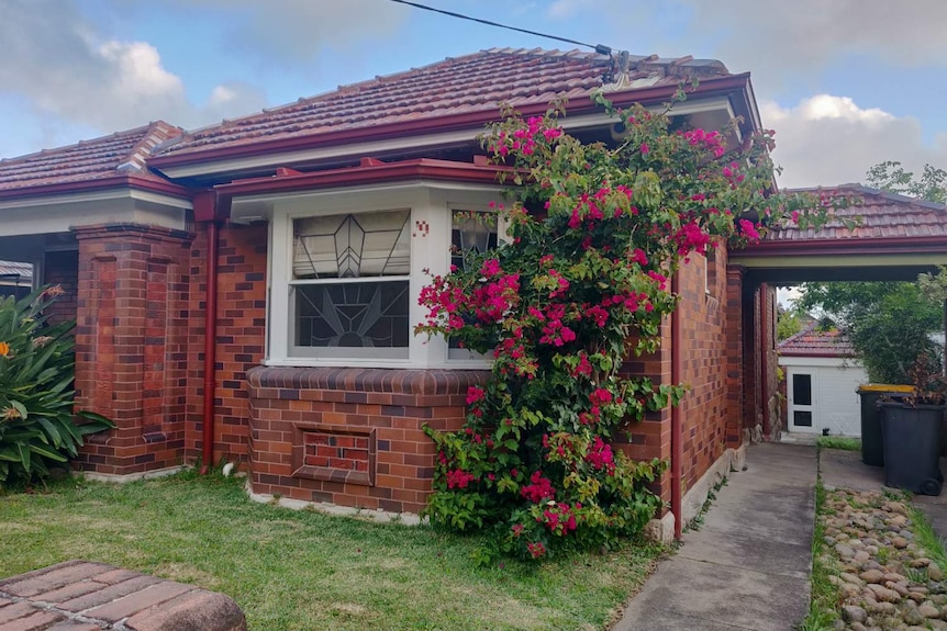 exterior of a suburban home covered in flowers