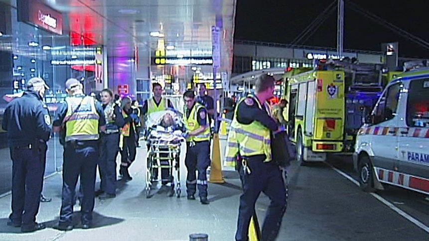 Emergency services remove an injured person after an accident outside Melbourne Airport.