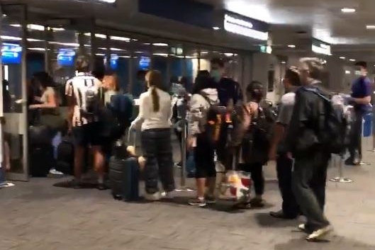 long crowds at an airport terminal
