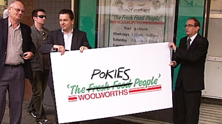 Tim Costello (L) Nick Xenophon (C) and protest sign