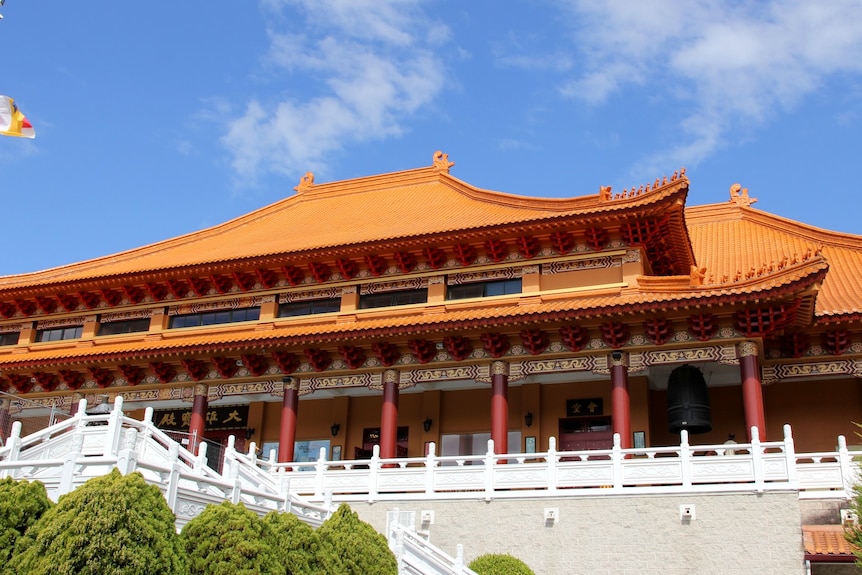 image of terracotta temple against blue sky.