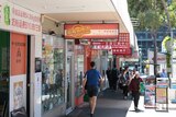 A generic view of a street in central Box Hill with lots of signage in Chinese.