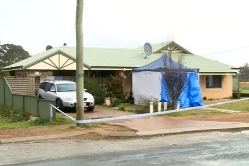 A house with a police forensic tent outside