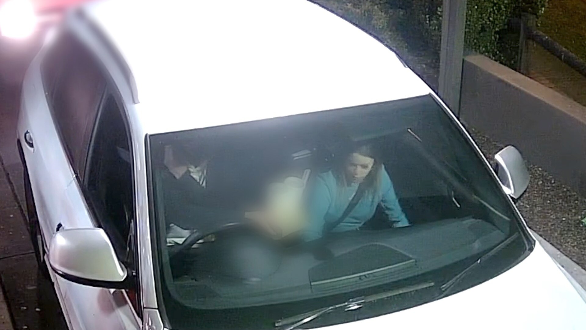 A woman in a white car