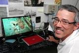 David Mearns looks at footage of the wreckage of AHS Centaur.