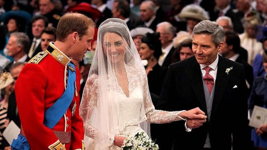 LtoR Prince William smiles at his bride Kate Middleton
