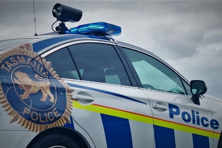 Tasmania Police car with lights on.