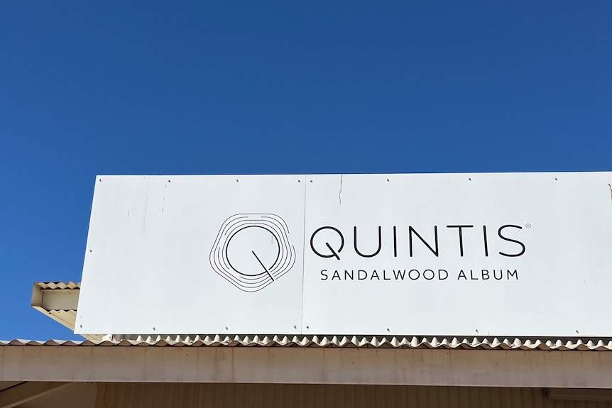 A sign saying Quintis on the roof of a building