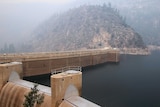 Smoke from a rim fire lingers over a dam in Yosemite National Park.