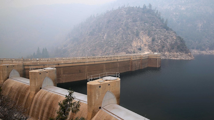Smoke from a rim fire lingers over a dam in Yosemite National Park.