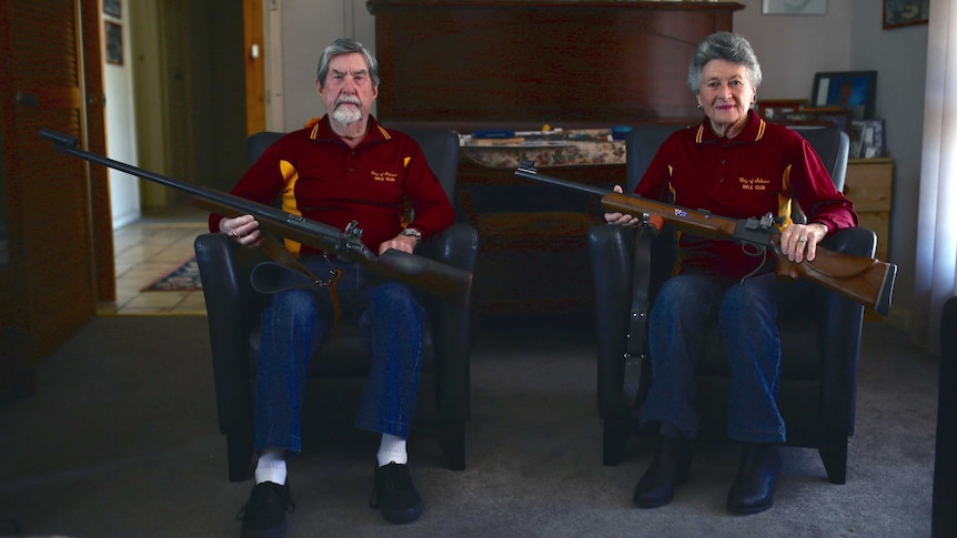 Betty Concanen and husband Merv sitting on chairs with their rifles resting across their laps.