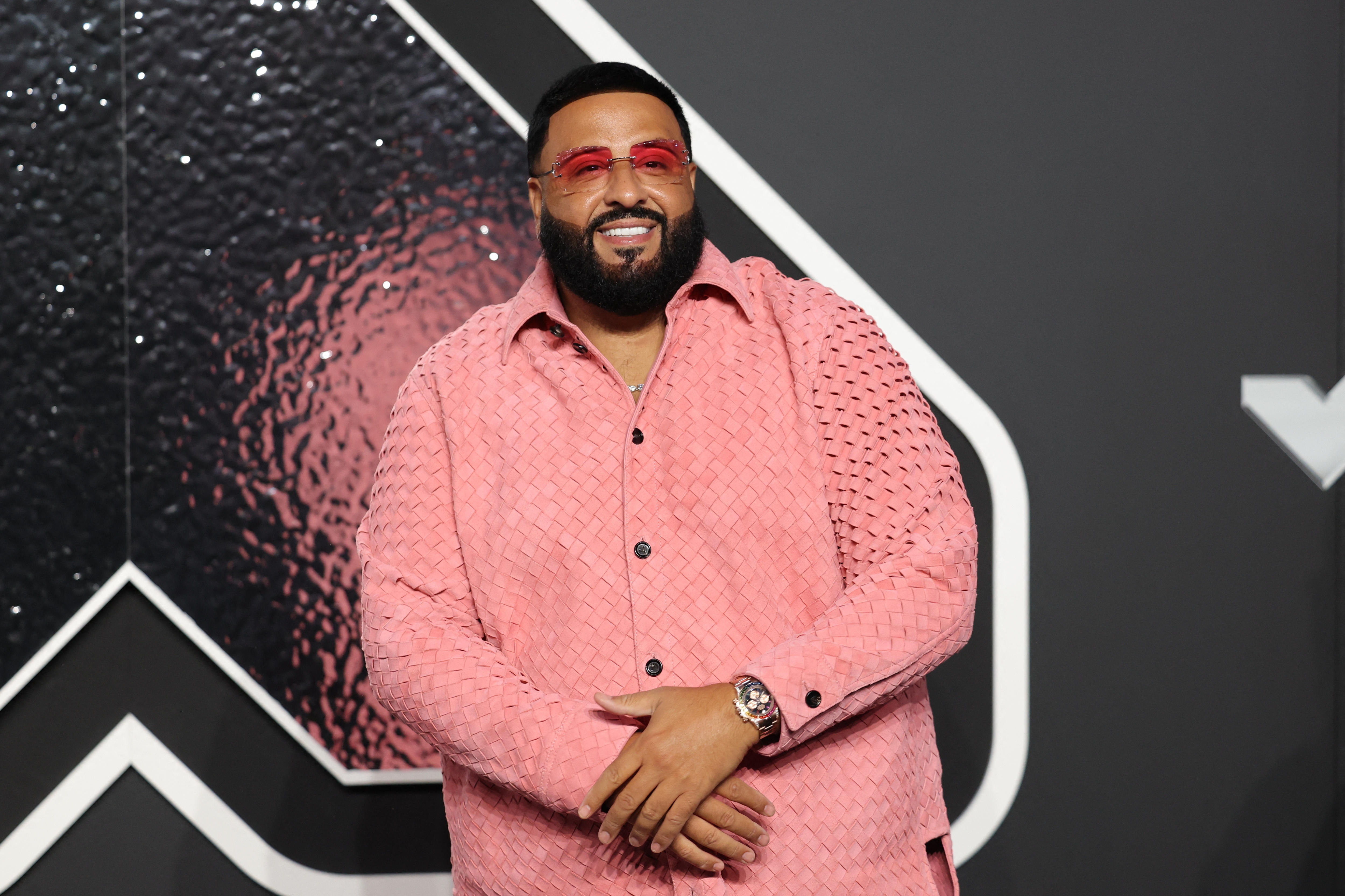 DJ Khaled on the VMAs red carpet wearing a pink suit with pink clear sunglasses