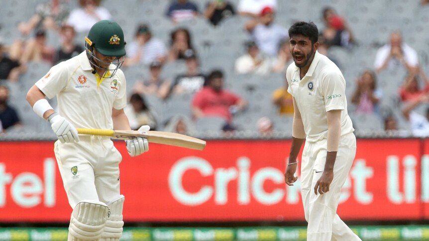 Jasprit Bumrah celebrates as Marcus Harris looks to the ground after his dismissal at the MCG