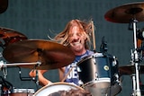 Taylor Hawkins drumming during a performance.