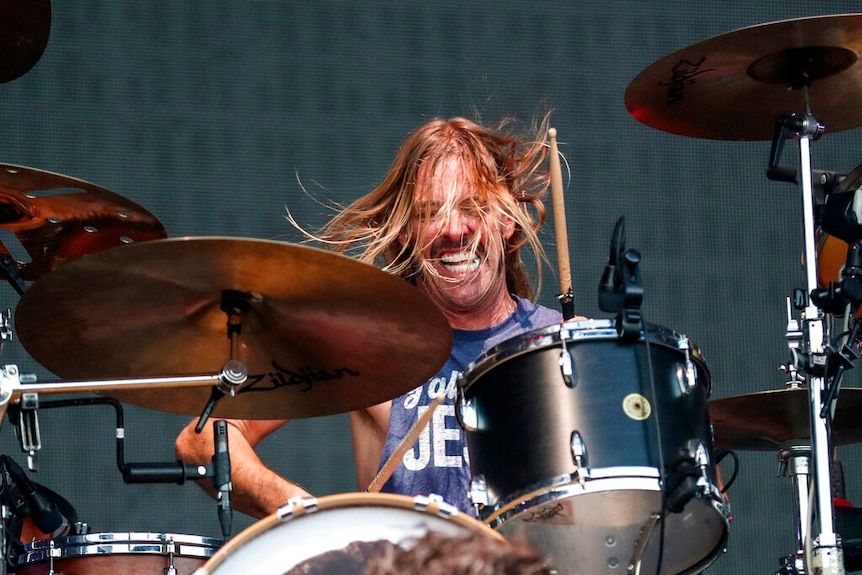 Taylor Hawkins drumming during a performance.