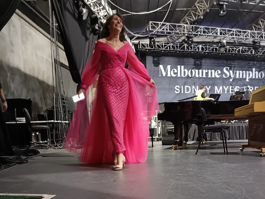 Mairi Nicolson walking off stage at the Sidney Myer Music Bowl in a pink gown.